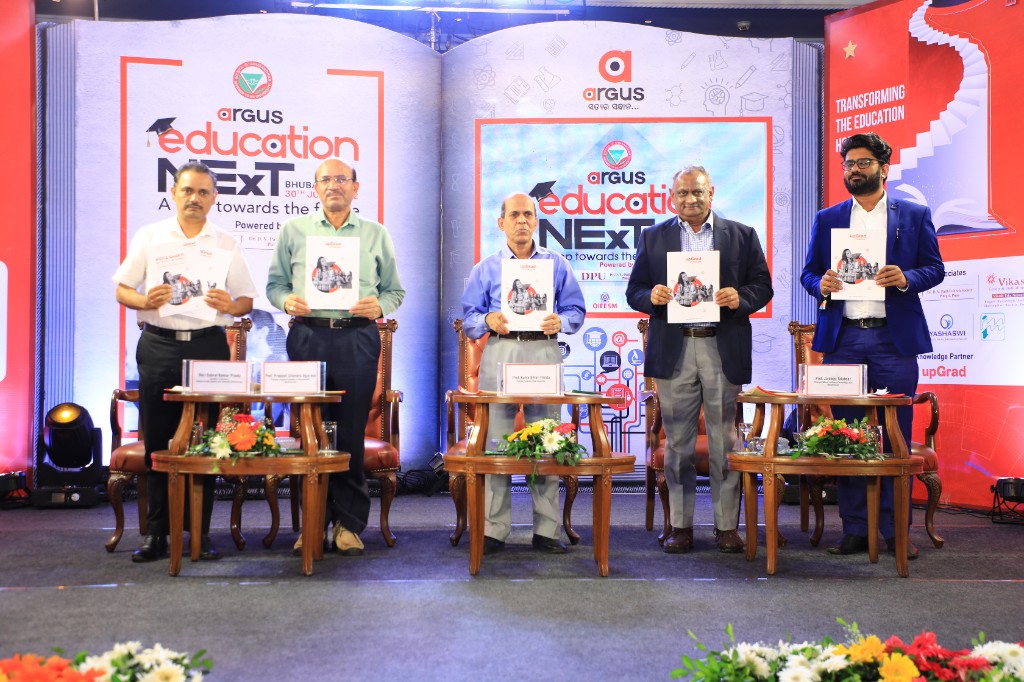 Partners on stage holding programme booklets at the Season 1 launch