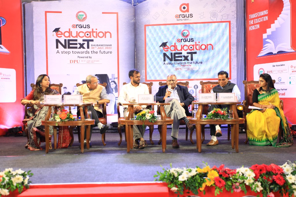 Six-person panel discussion with open-book stage design