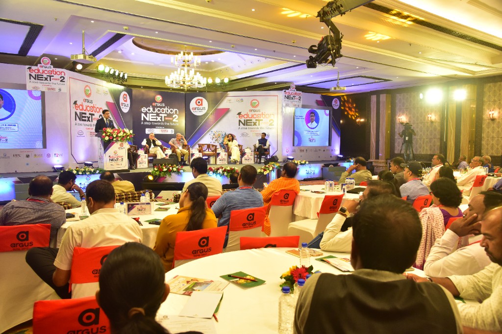 Delegates reading programme materials at a round table