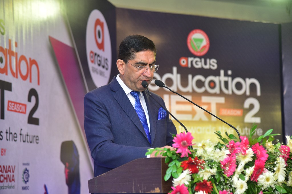 Speaker at podium with Education Next Season 2 backdrop