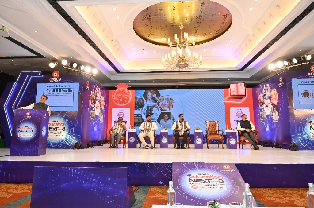 Speaker at a branded podium with panelists seated on the Season 3 stage