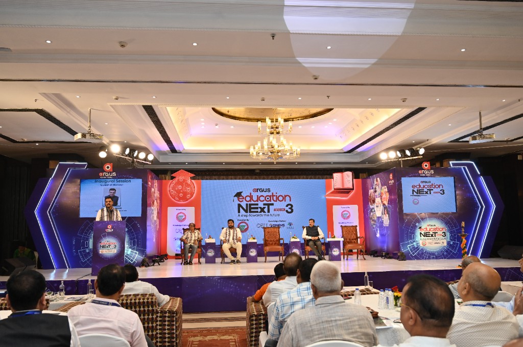 Wide view of the Season 3 stage with audience seated at round tables