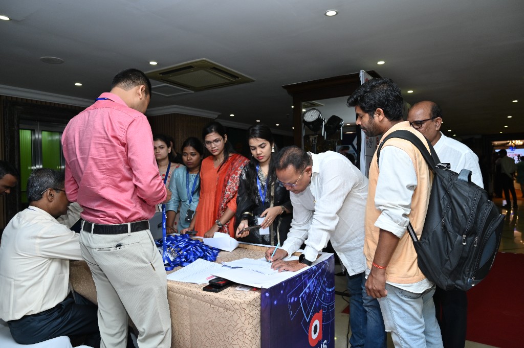 Registration desk with staff assisting Season 3 attendees
