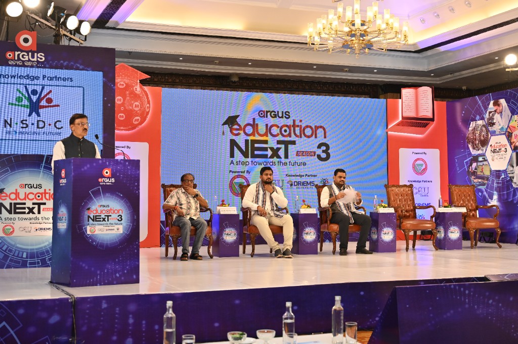Speaker and panelists with Argus Education Next Season 3 backdrop and partner logos
